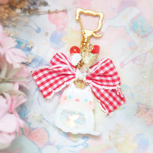 White cat with frilly checkered ribbon