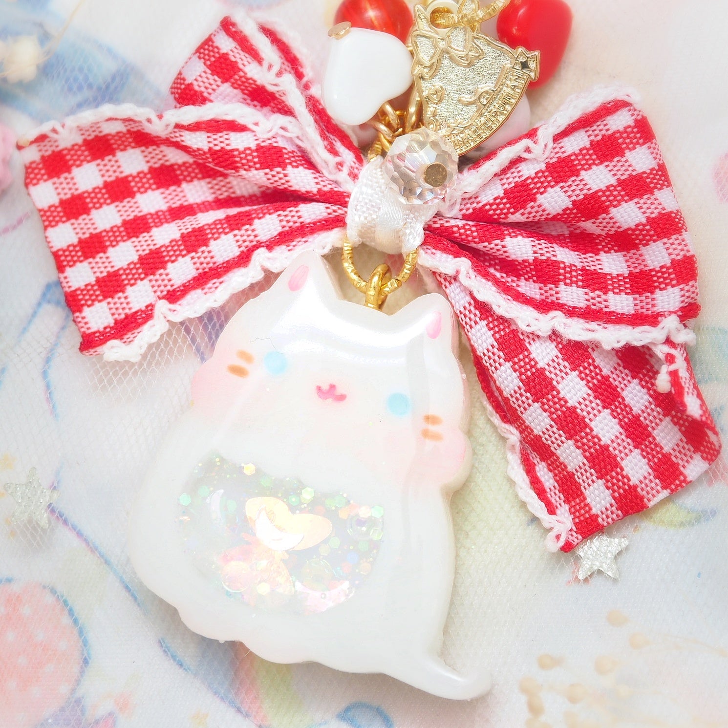 White cat with frilly checkered ribbon