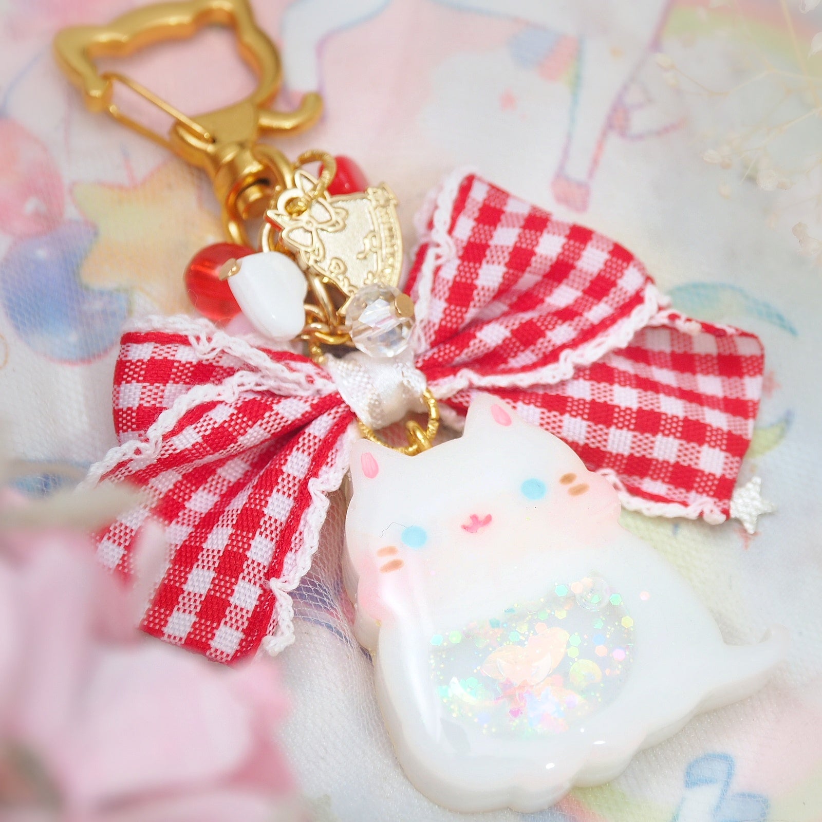 White cat with frilly checkered ribbon