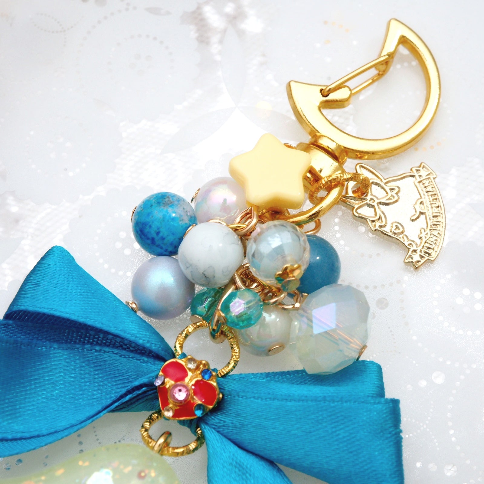 Spinning Orgel Charm (Teal Ribbon)