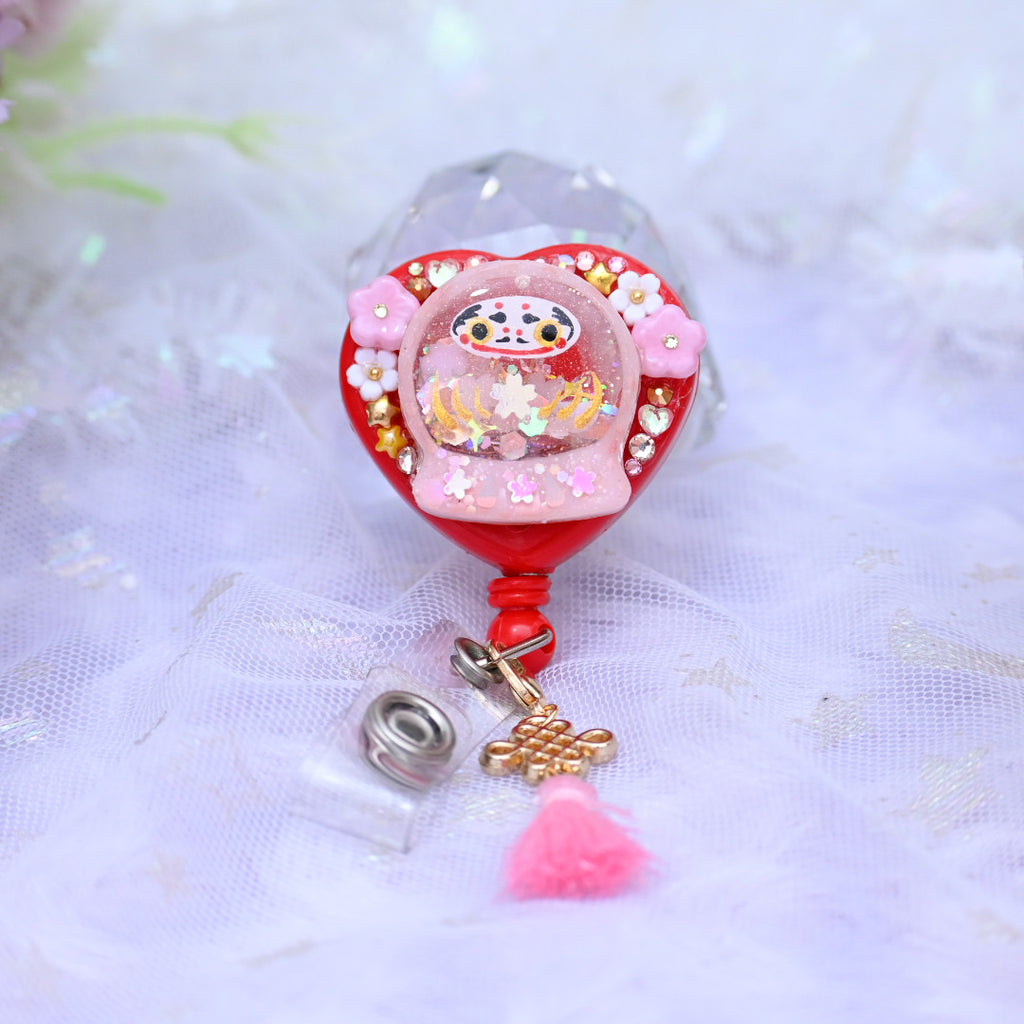 Tiny Pink Daruma badge reel