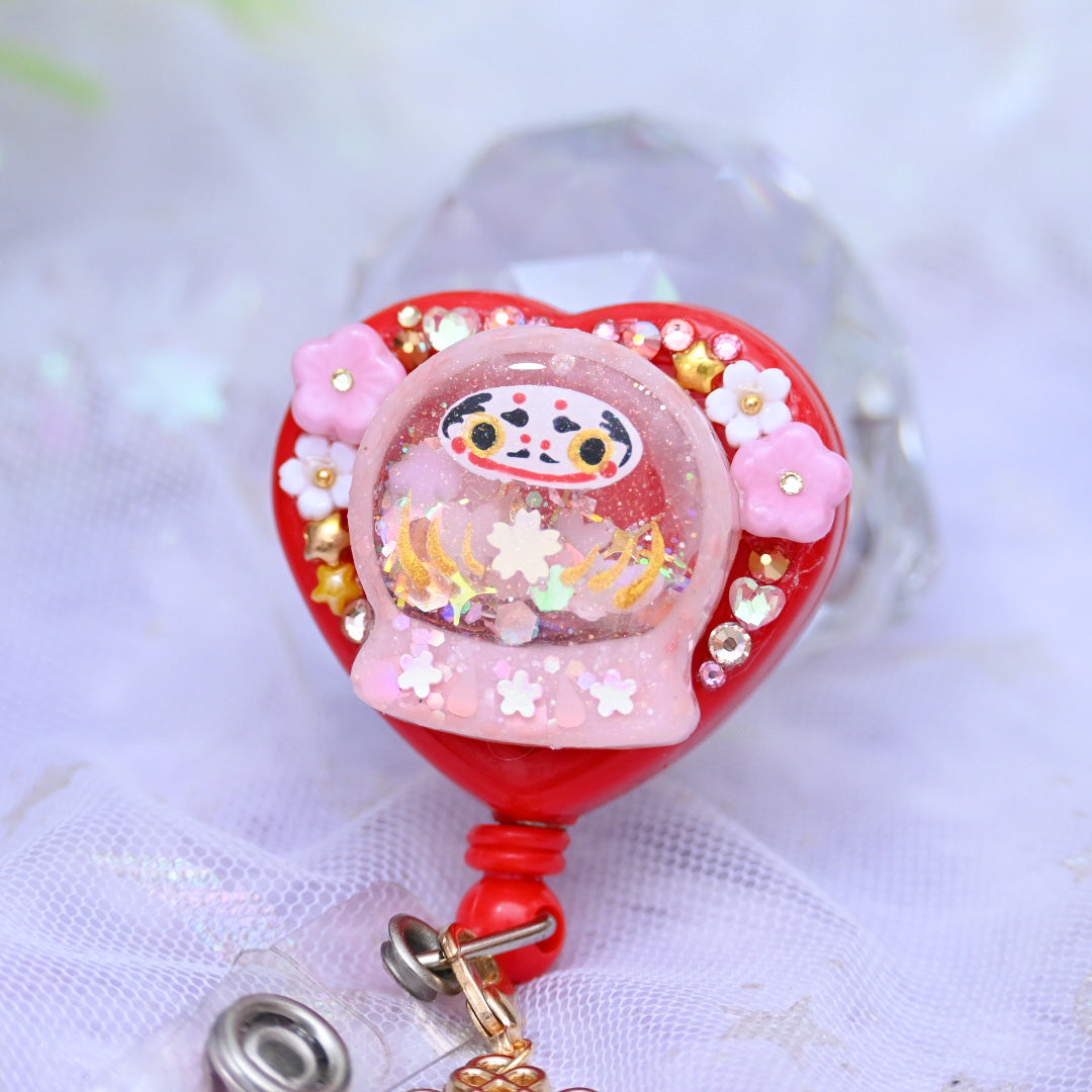 Tiny Pink Daruma badge reel